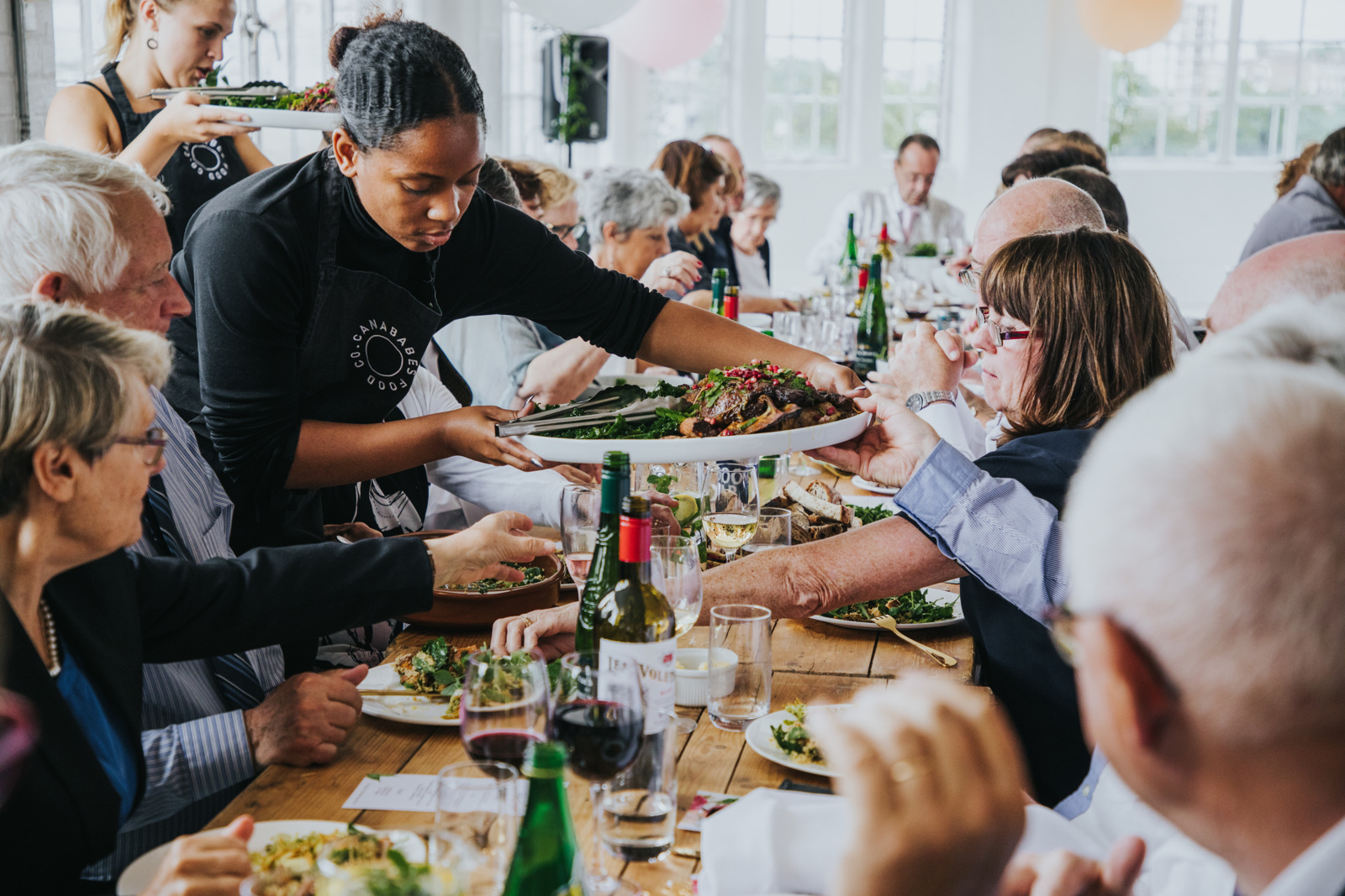 A group of people eating a steated dinner